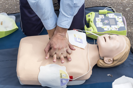 instructor showing cpr on training doll. first aid, cpr lessons